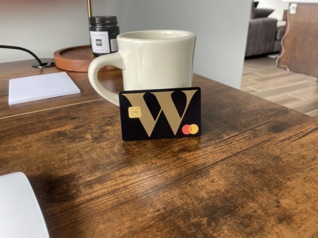 Wealthsimple Cash In front of a coffee mug